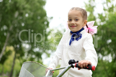 Girl on a bicycle in the green park