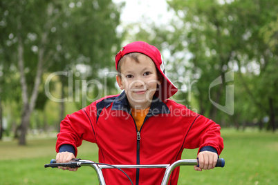 Boy on a bicycle in the green park