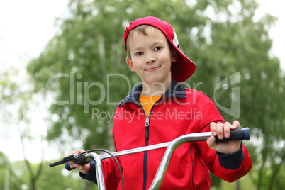 Boy on a bicycle in the green park