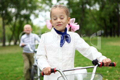 Girl on a bicycle in the green park