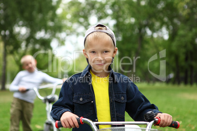 Boy on a bicycle in the green park