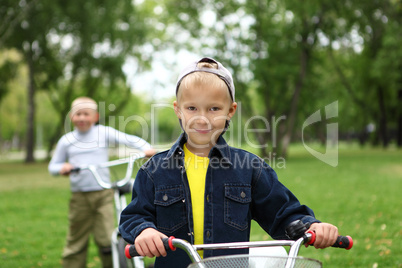 Boy on a bicycle in the green park