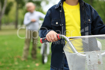 Boy on a bicycle in the green park