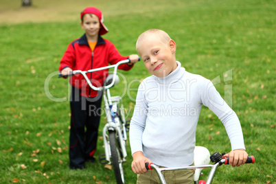 Boy on a bicycle in the green park