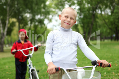 Boy on a bicycle in the green park