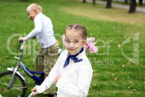 Girl on a bicycle in the green park