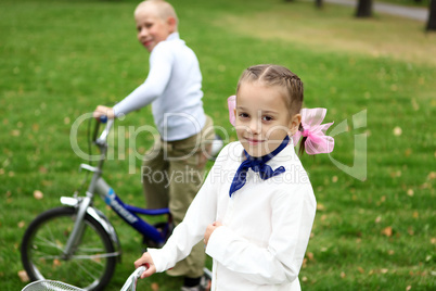 Girl on a bicycle in the green park