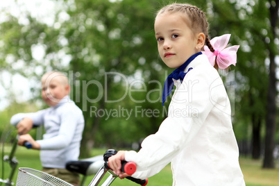 Girl on a bicycle in the green park