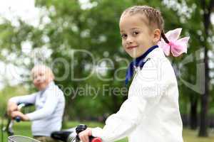 Girl on a bicycle in the green park