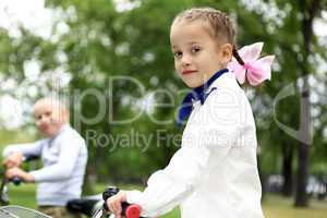 Girl on a bicycle in the green park