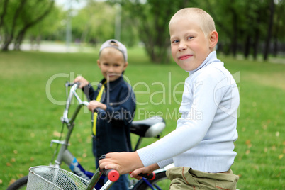 Boy on a bicycle in the green park