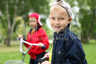 Boy on a bicycle in the green park