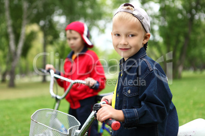 Boy on a bicycle in the green park