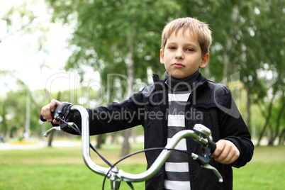 Boy on a bicycle in the green park