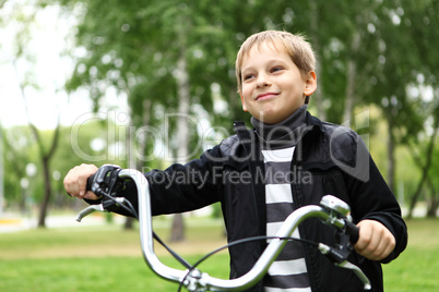 Boy on a bicycle in the green park