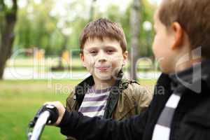 Boy on a bicycle in the green park