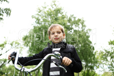 Boy on a bicycle in the green park