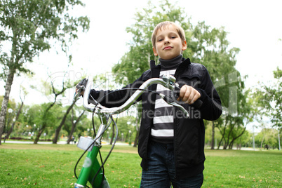 Boy on a bicycle in the green park