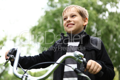 Boy on a bicycle in the green park