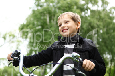 Boy on a bicycle in the green park