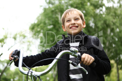 Boy on a bicycle in the green park