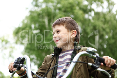 Boy on a bicycle in the green park