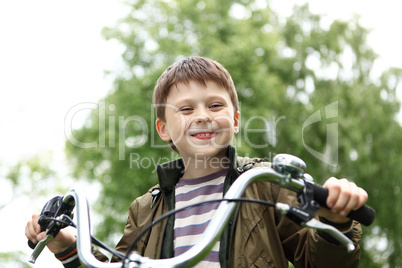 Boy on a bicycle in the green park