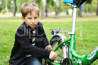 Boy on a bicycle in the green park