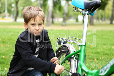 Boy on a bicycle in the green park