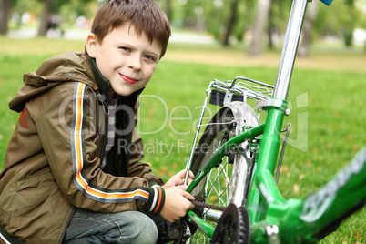 Boy on a bicycle in the green park