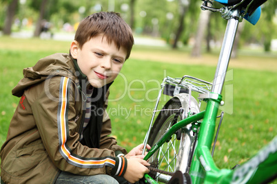 Boy on a bicycle in the green park