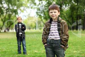 Boy with a friend in the green park