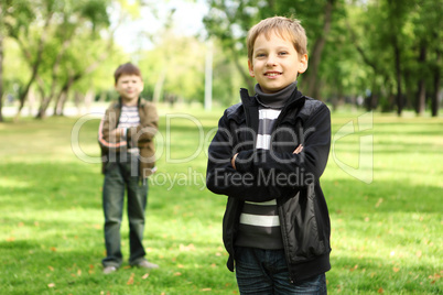 Boy with a friend in the green park