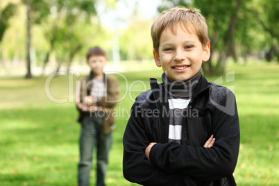 Boy with a friend in the green park