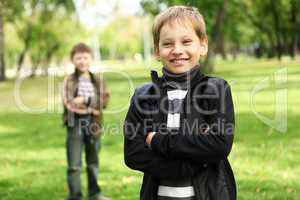Boy with a friend in the green park