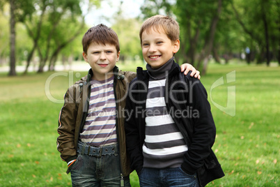 Boy with a friend in the green park