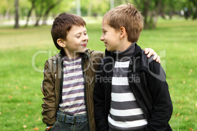 Boy with a friend in the green park