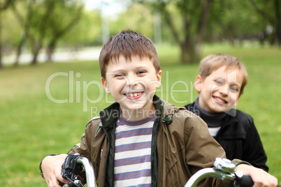 Boy on a bicycle in the green park