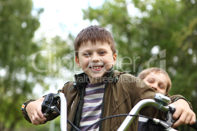 Boy on a bicycle in the green park