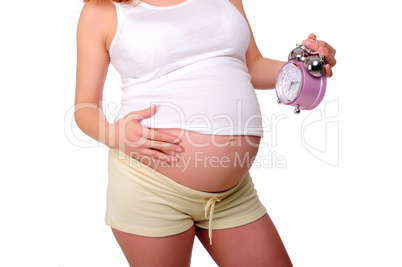 Young redhead pregnant mother holding a clock