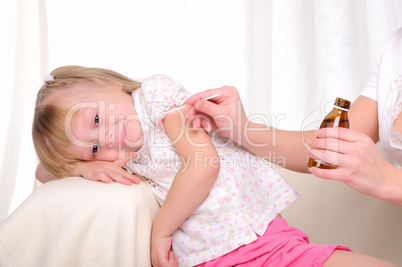 Little girl drinking cough syrup