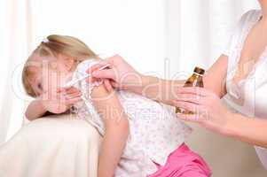 Little girl drinking cough syrup