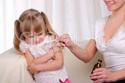 Little girl drinking cough syrup