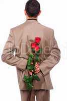 young man hides behind a rose