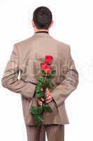 young man hides behind a rose