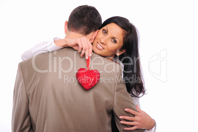 young girl hugs her man and holding a red heart