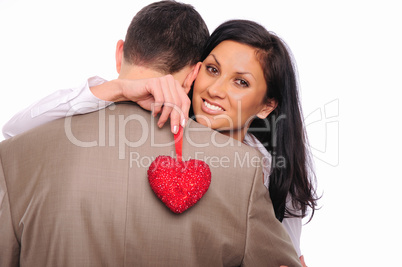 young girl hugs her man and holding a red heart