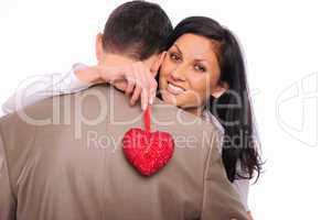 young girl hugs her man and holding a red heart