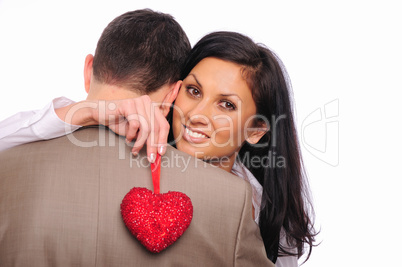 young girl hugs her man and holding a red heart