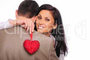 young girl hugs her man and holding a red heart